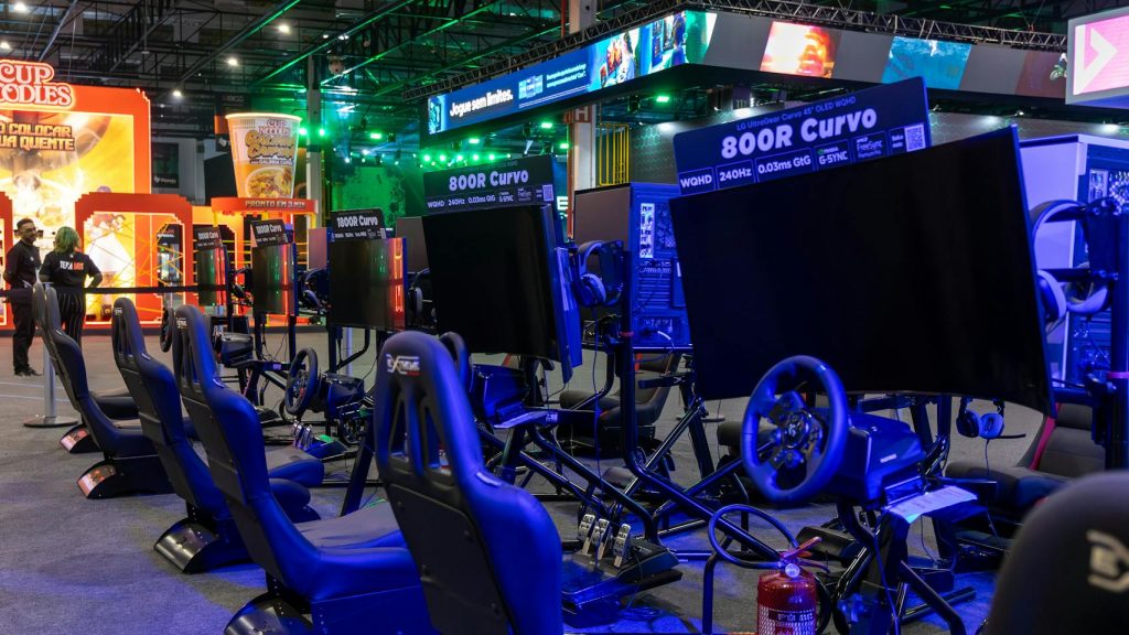 Virtual racing arcade setup with gaming simulators in a vibrant evening ambiance.