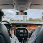 Father and son bonding while driving, showcasing guidance and togetherness in a car's interior.