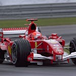 Ferrari Formula 1 car racing at high speed on the Indianapolis track, showcasing motorsport excitement.