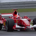 Ferrari Formula 1 car racing at high speed on the Indianapolis track, showcasing motorsport excitement.